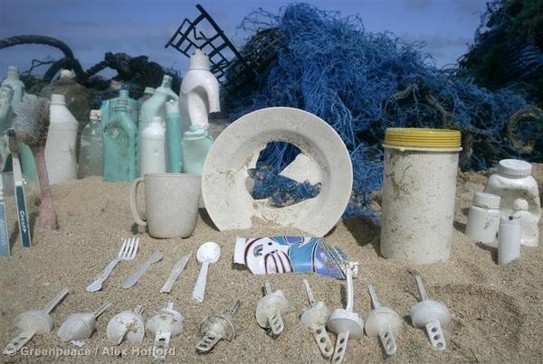 Plastic disposable items are displayed on a beach and the word ‘Trash’ is spelt out from the rubbish. 26 Oct, 2006  © Greenpeace / Alex Hofford