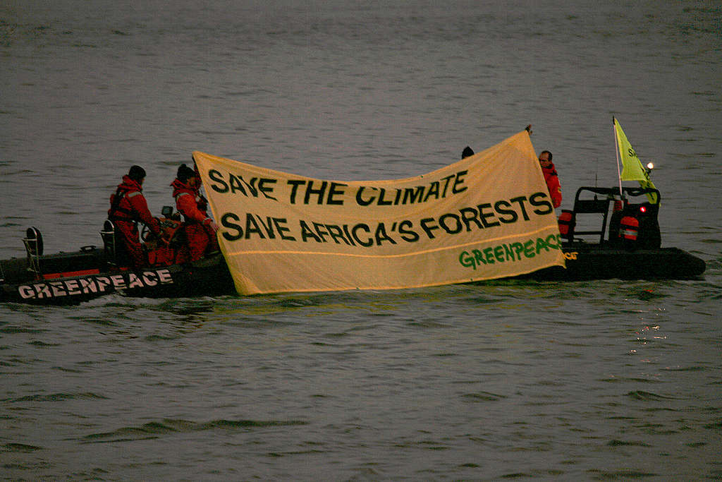 Banner Action during EU Africa Summit in Lisbon. © Greenpeace / Nick Cobbing