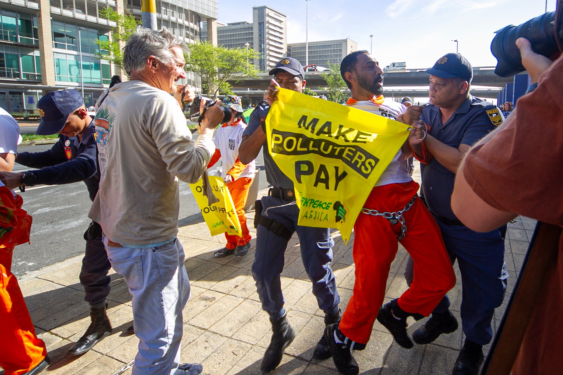 African Energy Week: Police drag away chained climate activists at Africa’s biggest OIL CONFERENCE