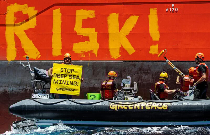 The discovery of dark oxygen underlines the risk of allowing deep sea mining to proceed. Greenpeace International activists paint the word 'RISK!' on the starboard side of Normand Energy, a vessel chartered by the Belgian deep sea mining company Global Sea Mineral Resources (GSR). The Rainbow Warrior is bearing witness to equipment tests carried out by GSR using the Patania II nodule collector, at approximately 4500 metres deep in the Clarion Clipperton Zone. The mining company is aiming to commercially extract minerals from the seabed in the future.