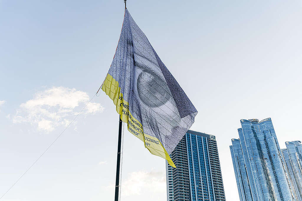 #WeAreWatching is a monumental flag with a giant eye composed of thousands of portraits from around the world, unfurled from a 10-storey crane as government representatives are gathering for the the fifth and final Intergovernmental Negotiating Committee (INC5) meeting for a Global Plastics Treaty. Greenpeace is collaborating with #WeAreWatching by artist Dan Acher to demand bold action. From November 25 to December 1, 2024 world leaders will meet in Busan, South Korea for the fifth and final round of negotiations of the Global Plastics Treaty - a once-in-a-generation opportunity to solve the plastics crisis. #WeAreWatching is a monumental flag with a giant eye composed of thousands of portraits from around the world, unfurled from a 10-storey crane as government representatives are gathering for the the fifth and final Intergovernmental Negotiating Committee (INC5) meeting for a Global Plastics Treaty. Greenpeace is collaborating with #WeAreWatching by artist Dan Acher to demand bold action. From November 25 to December 1, 2024 world leaders will meet in Busan, South Korea for the fifth and final round of negotiations of the Global Plastics Treaty - a once-in-a-generation opportunity to solve the plastics crisis.