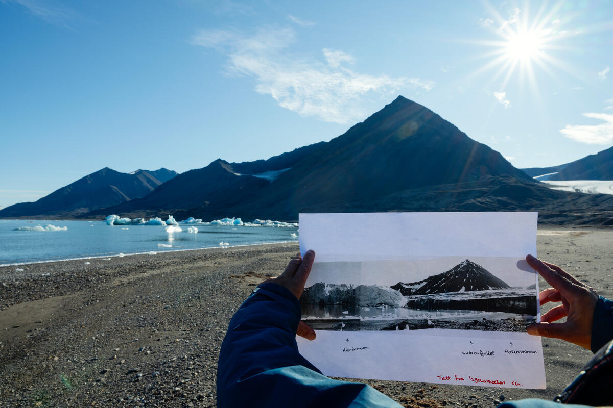A Greenpeace crew holds an archive panorama image from the Norwegian Polar Institute from 1967 showing the glaciers Kongsvegen and Pedersenbreen merging and surrounding the mountain Nielsenfjellet outside Ny Ålesund, Svalbard. Greenpeace has commissioned photographer Christian Aslund to continue a project he began in 2002 - to carry out visual research of glaciers in Svalbard and document their retreat over time. While sailing aboard the Greenpeace vessel ‘Witness’, Aslund revisited glaciers he first documented in 2002 as well as photographing others, new to this project. The Arctic has been warming more than twice as fast as the rest of the world, due to "Arctic amplification." Rapid warming of the Arctic region has global consequences. Melting glaciers and ice sheets are causing sea levels to rise. Melting sea ice reveals the dark ocean that absorbs heat instead of reflecting it like ice and snow and has far-reaching impacts on weather patterns. Norwegian Polar Institute Reference image: NP051260