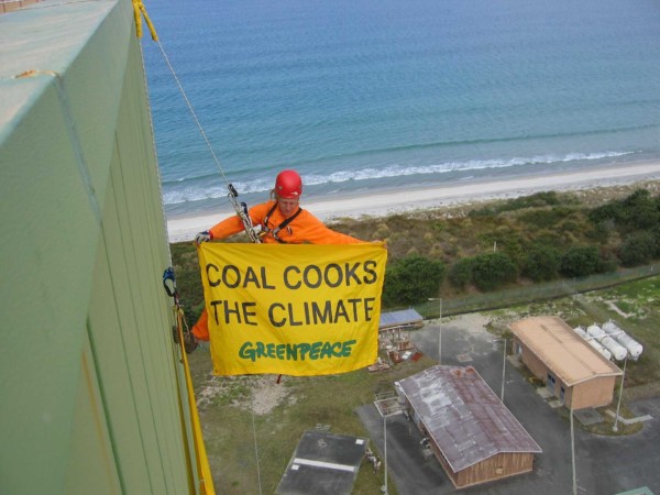 Greenpeace organised "Stop Marsden B-each Day Out", drawing strong local support from Ruakaka and Whangarei residents, along with people from as far away as the Bay of Islands. Representing the local hapu (the basic political unit within Maori society), play centres, the fire service and schools. An activist climbes the power station in protest with a banner reading "Coal Cooks The Climate".