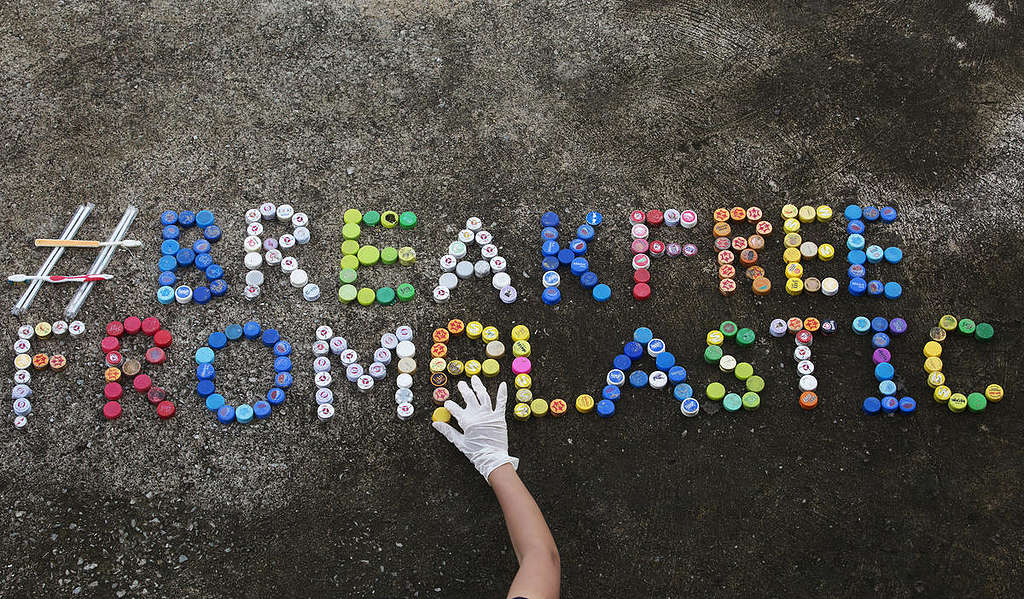 #Break Free from Plastic is written on the beach using collected bottle caps collected by Greenpeace Southeast Asia