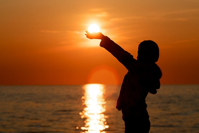 Child holding sun