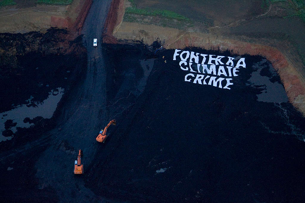 Greenpeace activists shut down a pit of a New Vale lignite coal mine near Invercargill, used by Fonterra to help fuel operations at its nearby Edendale dairy factory, labelling it a Fonterra Climate Crime. At dawn, activists unfurled a massive 40x40 meter banner reading Fonterra Climate Crime on the ground of the opencast mine. Other activists blocked one of the entrances and locked themselves onto some of the mine's machinery.