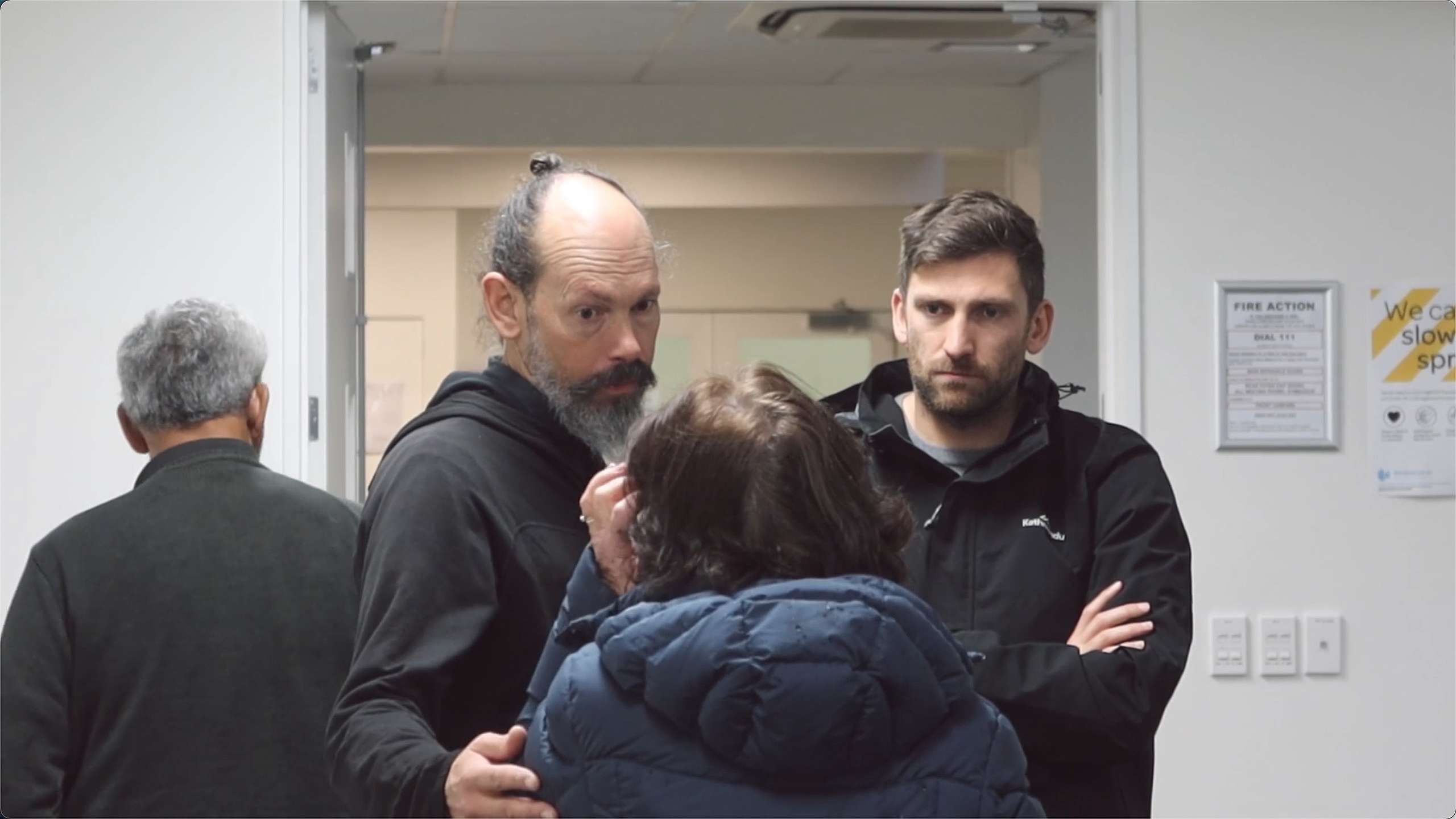 Picture of Steve Abel and TIm Chambers consoling a water testee