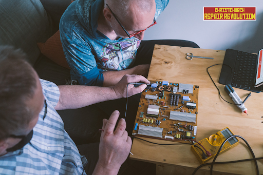 two people looking at an electronic panel