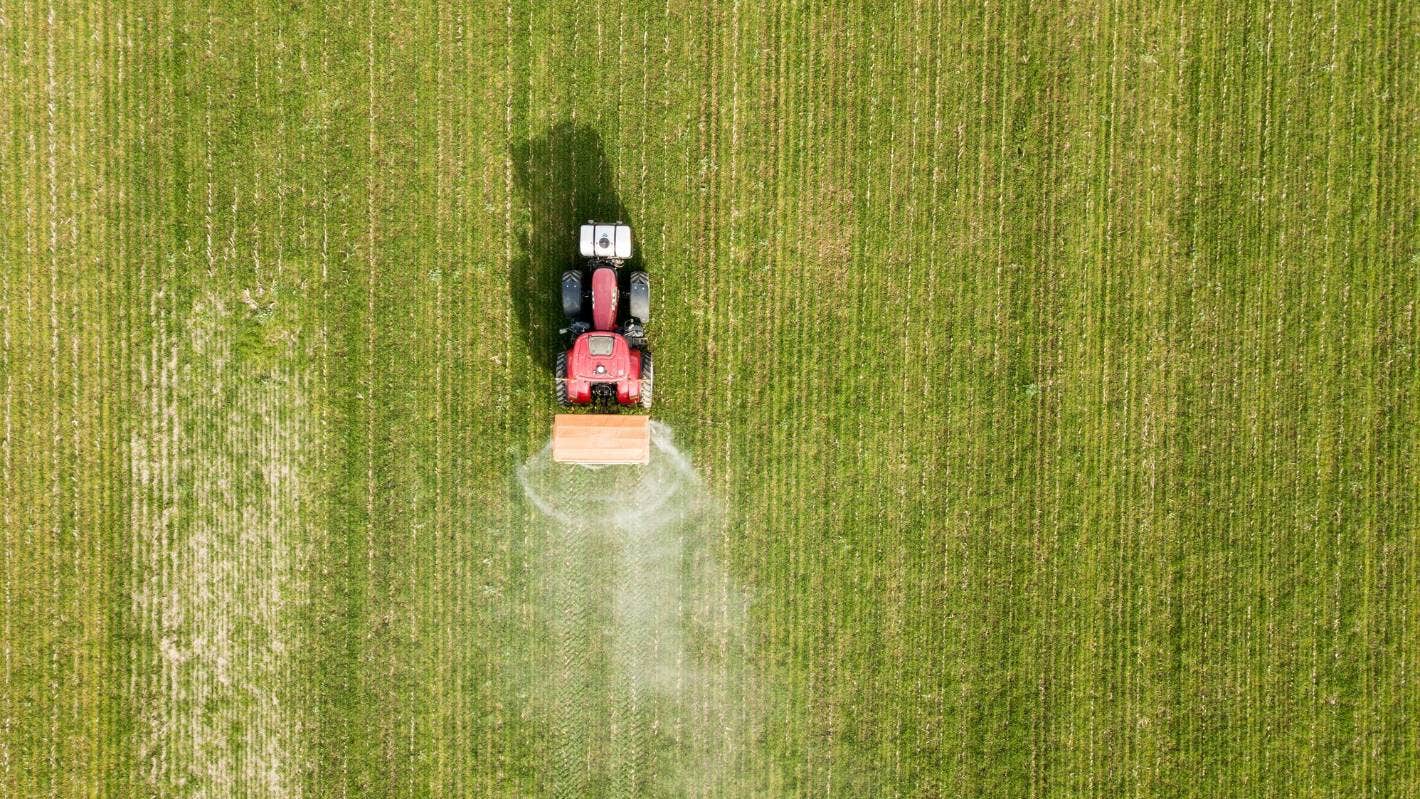 Birds eye view of a tractor spraying a ffield