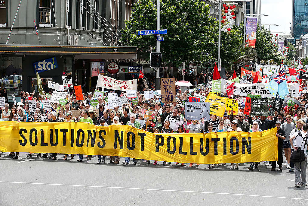 15,000 protesters marching up Queen Street, Auckland, carrying a large banner that reads 'Solutions not pollution'. 15,000 protesters marching up Queen Street, Auckland, carrying a large banner that reads 'Solutions not pollution'.