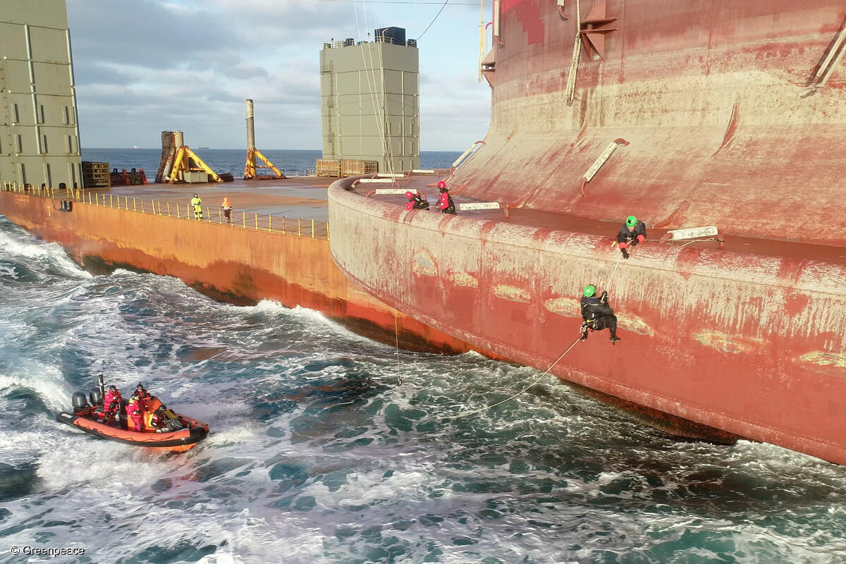 Two more Greenpeace climbers board the Shell oil platform that is being transported to an oilfield north of the Shetland Islands.