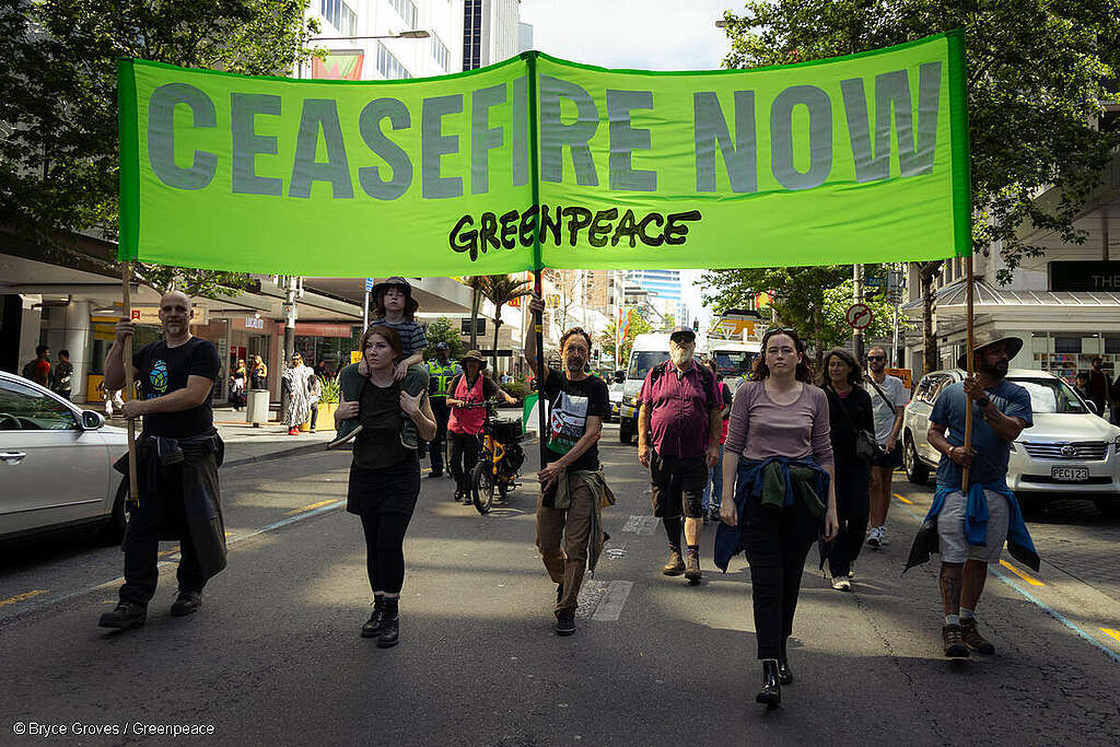 Greenpeace Aotearoa staff with a banner reading "Ceasefire Now" at a march in Auckland, New Zealand, for peace in the Israel/Palestine conflict.