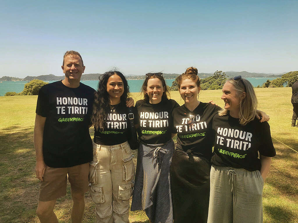 Russel Norman, Fili Fepulea’i, Jess Desmond, Niamh O’Flynn and Emma Page of Greenpeace Aotearoa at Waitangi wearing Honour TeTiriti / Toitū Te Tiriti shirts in 2024
