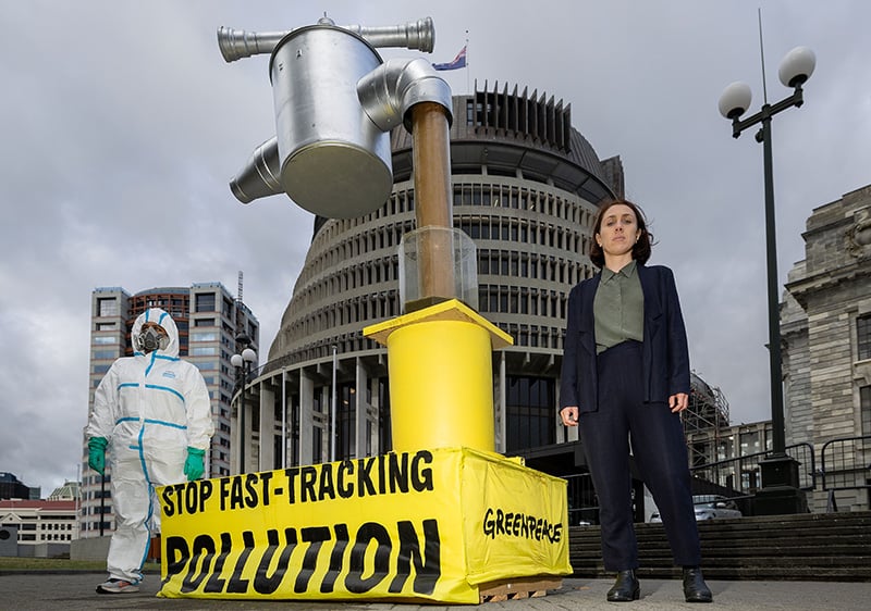 Greenpeace activists install a giant effluent tap at parliament sporting a stop fast-tracking pollution banner.