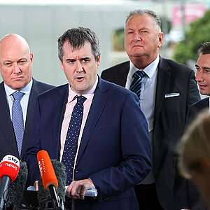 Prime Minister Christopher Luxon speaks to the media along with ministers Chris Bishop, Shane Jones and Simeon Brown during a 100-day plan announcement at Basin Reserve on March 07, 2024 in Wellington, New Zealand where they were questioned by Greenpeace campaigner Gen Toop about the risk of freshwater pollution that their plans pose.