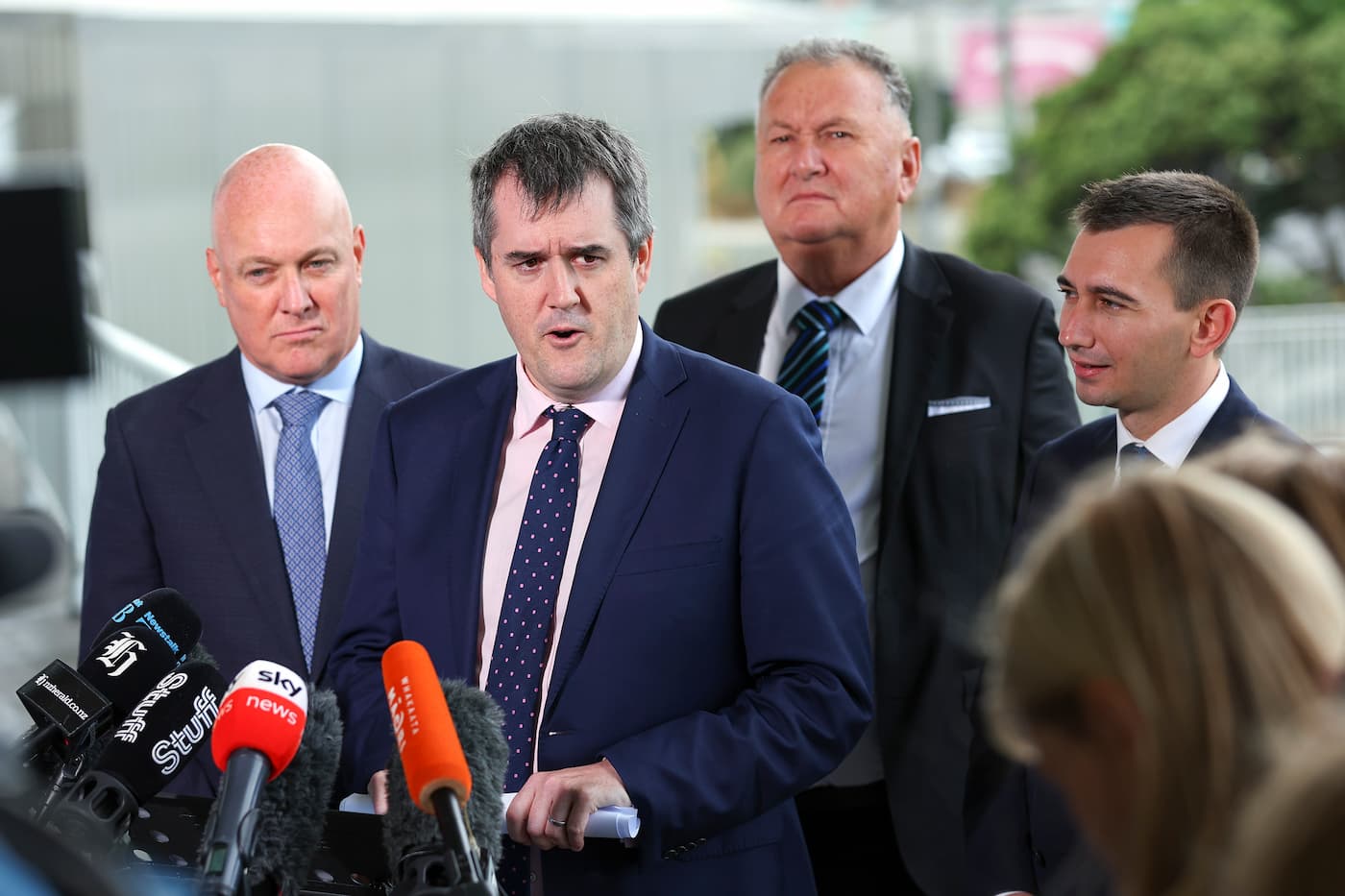 Prime Minister Christopher Luxon speaks to the media along with ministers Chris Bishop, Shane Jones and Simeon Brown during a 100-day plan announcement at Basin Reserve on March 07, 2024 in Wellington, New Zealand where they were questioned by Greenpeace campaigner Gen Toop about the risk of freshwater pollution that their plans pose.
