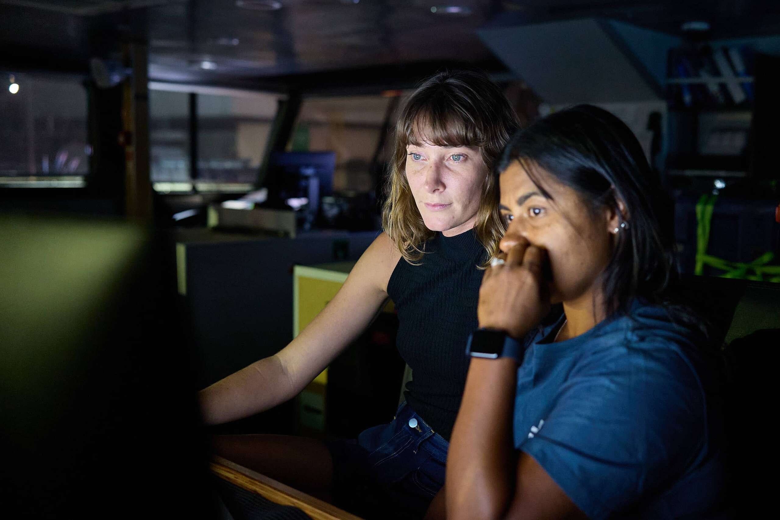 Dr Paige Maroni and lead scientist Kat Goddard look at screen showing images from an underwater camera