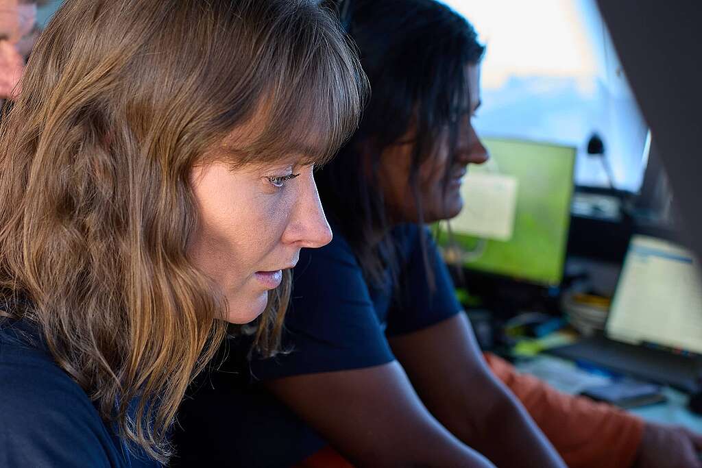 Dr Paige Maroni and lead scientist Kat Goddard look at screen showing images from the deep sea DropCam © Greenpeace Aotearoa Dr Paige Maroni and lead scientist Kat Goddard look at screen showing images from the deep sea DropCam © Greenpeace Aotearoa