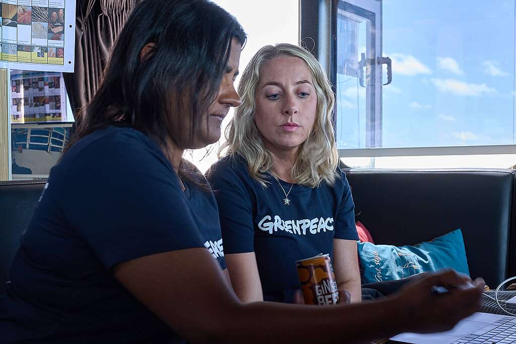 Lead scientist Kat sits with oceans campaigner Ellie, as they look at images from deep sea cameras on a laptop Lead scientist Kat sits with oceans campaigner Ellie, as they look at images from deep sea cameras on a laptop