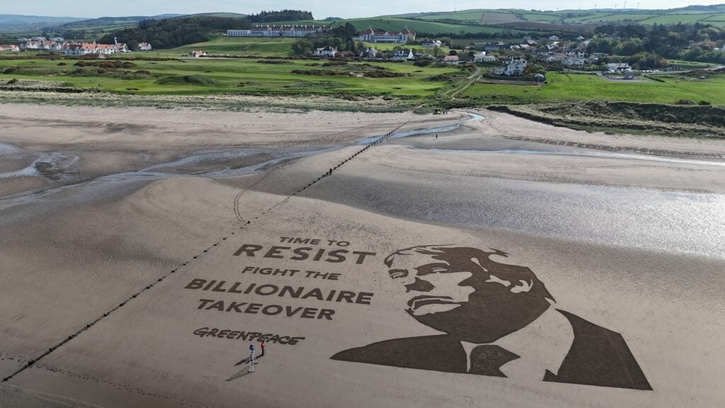 Greenpeace UK activists have created a giant artwork of US President Donald Trump on the beach next to his golf course in South Ayrshire.
