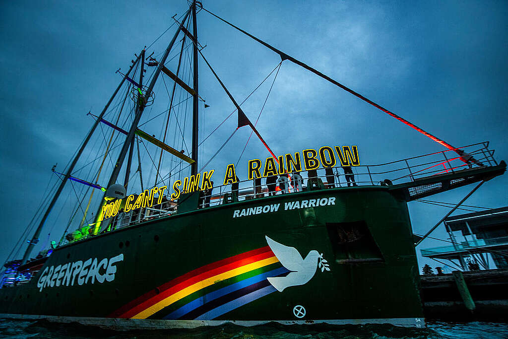 You Can't Sink a Rainbow - Action in Aucland, New Zealand The Rainbow Warrior is lit up as a “beacon of resistance” in Auckland today on the eve of the 40th anniversary of the bombing of the original Rainbow Warrior by French Government agents in 1985.
Twenty crew and Greenpeace Aotearoa staff and volunteers hold letters of light spelling out the iconic phrase, You Can’t Sink A Rainbow.