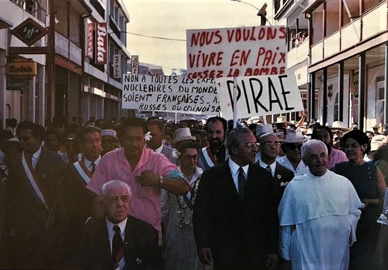 On 23 June 1973, Pouvana’a a Oopa (front centre), Francis Sanford (right of Pouvana‘a wearing suit jacket) and Jean-Jacques Servan-Schreiber (second from left with sash) marching against French nuclear testing, Pape'ete, Tahiti. Photo by Bengt Danielsson.