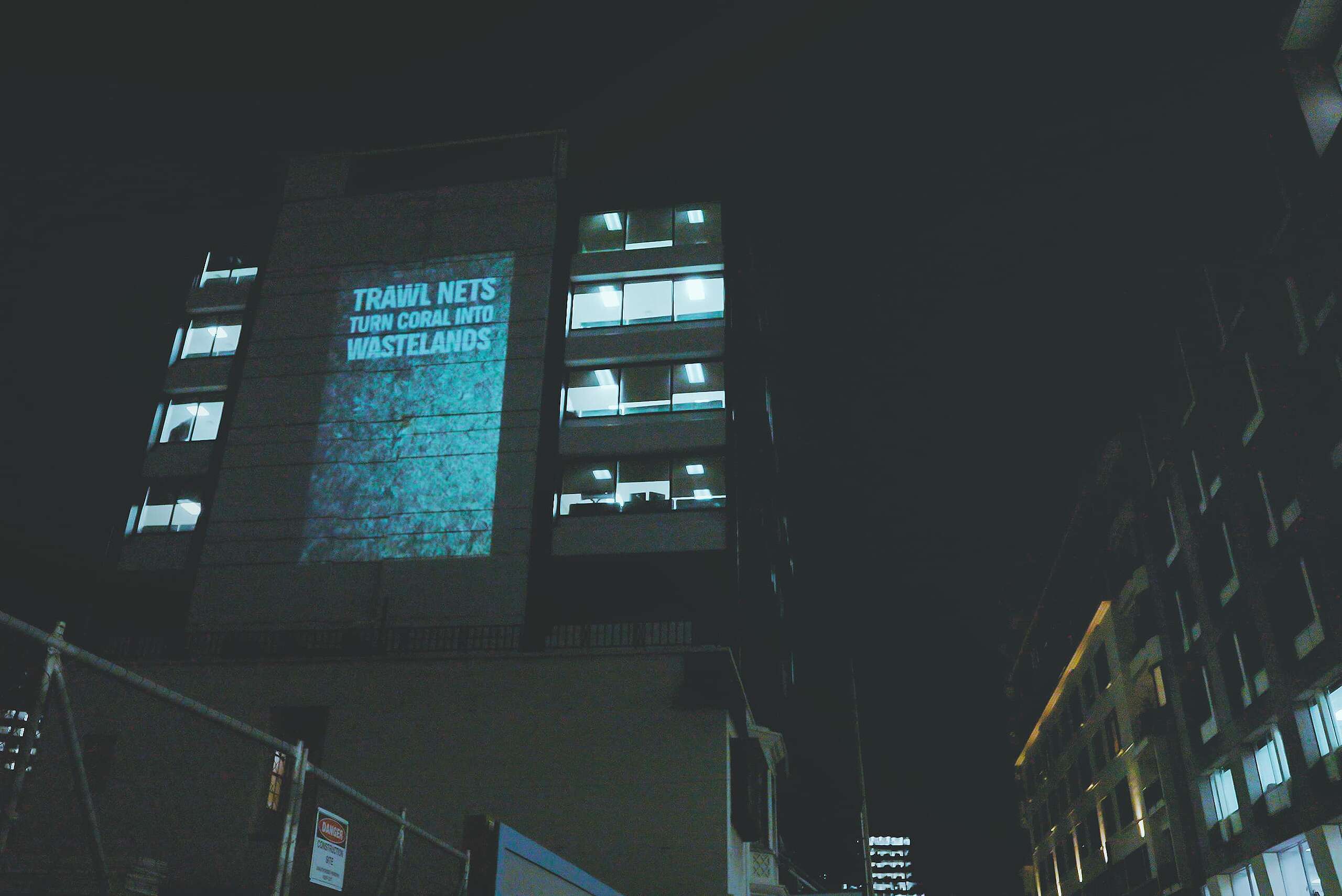 “Bottom trawling kills” message projected onto downtown Wellington building as fisheries meeting starts