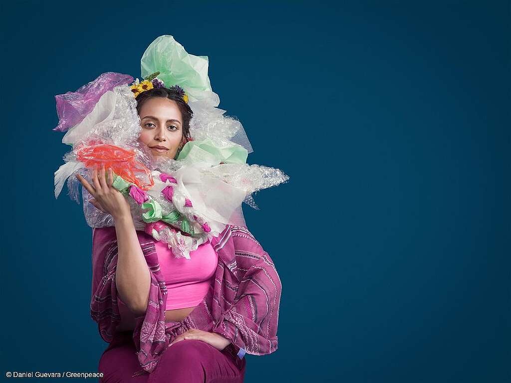 Una mujer con bolsas de plástico como adorno para el cabello para visualizar la patética dependencia del plástico en la vida diaria de las personas.