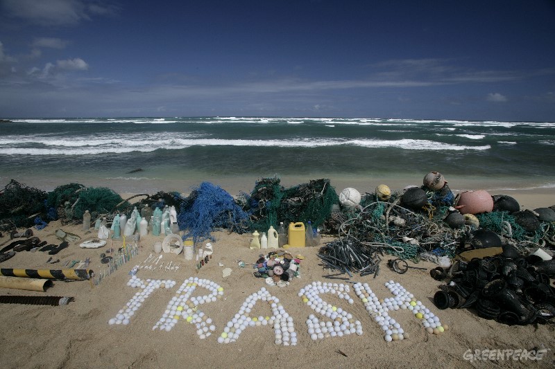 20061026 HONOLULU, HAWAI : UNITED STATES OF AMERICA  The word 'trash' is spelt out using golf balls on Kahuku beach, Honolulu, Hawaii, 26th October 2006. The wide variety of items shown in this image highlight the diverse range of sources from which the plastics in our oceans originate. Greenpeace are highlighting the threat that plastic poses to the world's oceans.GREENPEACE / ALEX HOFFORD