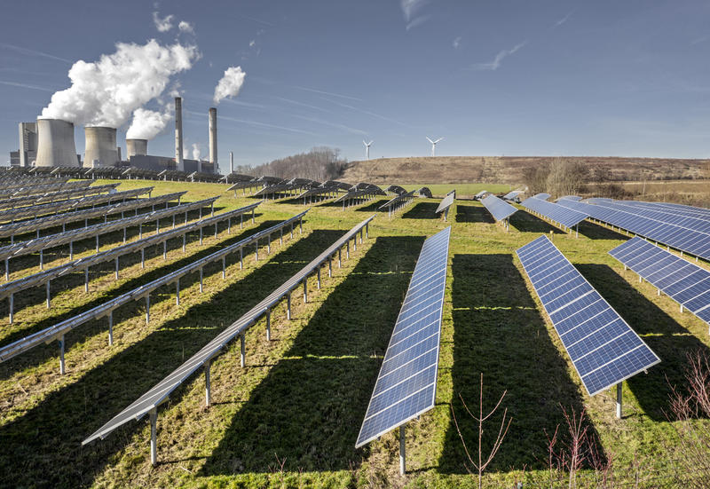 Соларни панели на фона на въглищна централа в Германия