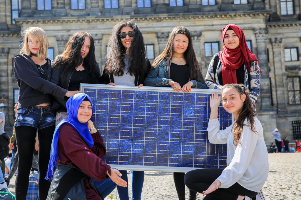 Amsterdam Citizens Holding a Solar Panel Amsterdam Citizens Holding a Solar Panel