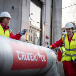 The entrance to the Canadian High Commission in Trafalgar Square has been blocked by climate campaigners who’ve built a huge oil pipeline around the building. The protest comes as Canadian PM Justin Trudeau touches down in London for the Commonwealth Heads of Government meeting. 
The pipeline is branded ‘Crudeau Oil’. Climbers have also scaled two entrance pillars to drop banners rebranding the building ‘Crudeau Oil HQ’.
The blockade is a protest against the Trudeau government’s plans to build a huge oil pipeline from the Alberta tar sands across indigenous lands to ports in British Columbia. The massive protest pipeline was installed at 6.30am this morning by 30 Greenpeace volunteers and runs from the main entrance of Canada House to the consular entrance on Cockspur Street.