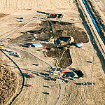 Workers continue their efforts on exposed sections of the Keystone pipeline. An estimated 210,000 gallons of oil leaked from the Keystone Pipeline in Marshall County, South Dakota, according to the pipeline's operator, TransCanada.  Crews shut down the pipeline and officials are investigating the cause of the leak.  A federal agency says a leak was caused by damage during construction in 2008.  The Pipeline and Hazardous Materials Safety Administration issued a corrective action report  on the estimated 210,000-gallon oil spill. The report says a weight installed on the pipeline nearly a decade ago may have damaged the pipeline and coating.
