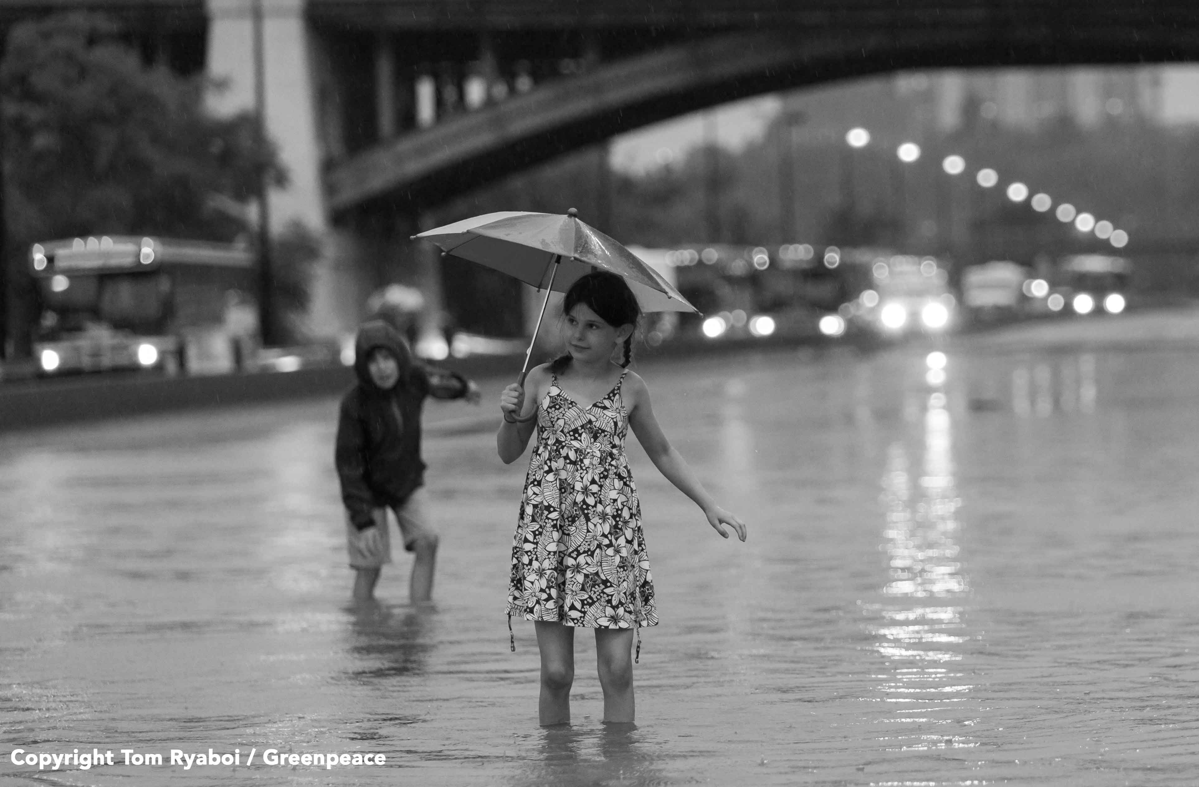 Girl walks through water on the flooded DVP during the July 2013 flash flood