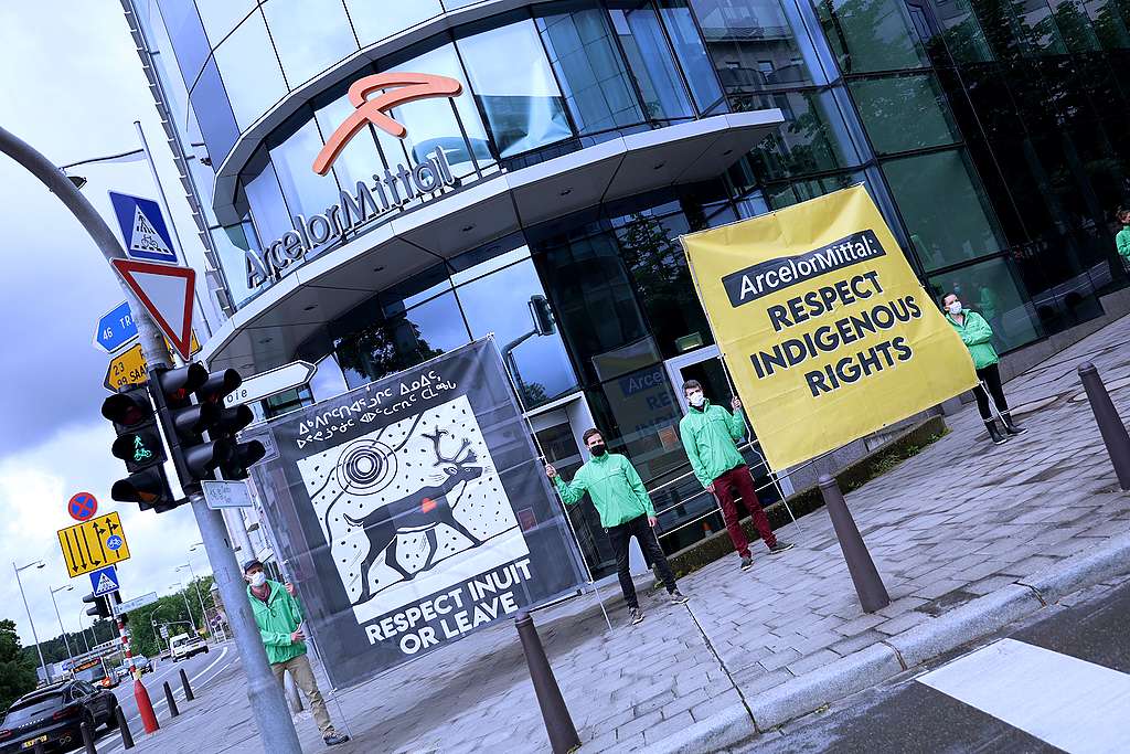 Greenpeace activists protest in solidarity with the Nuluujaat Land Guardians at the global headquarters of ArcelorMittal in Luxembourg.