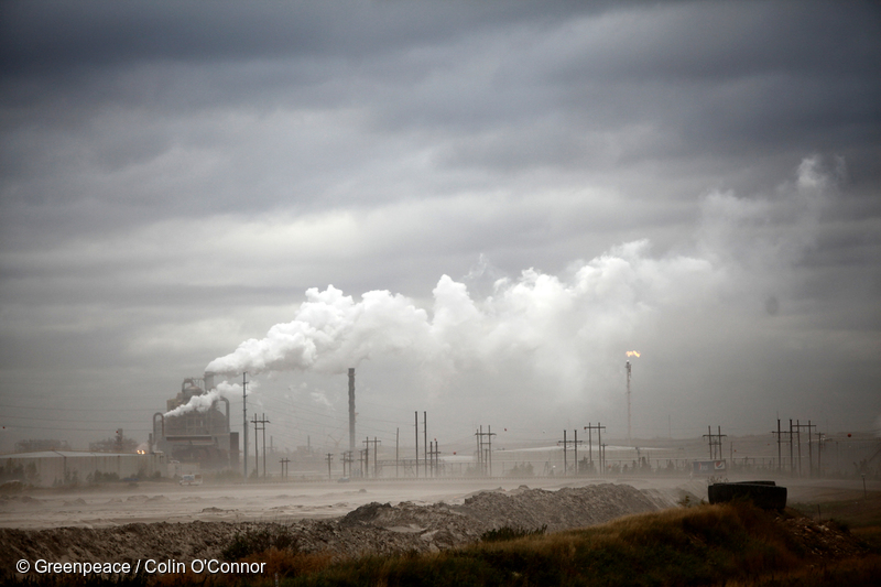 smoky refinery in the distance