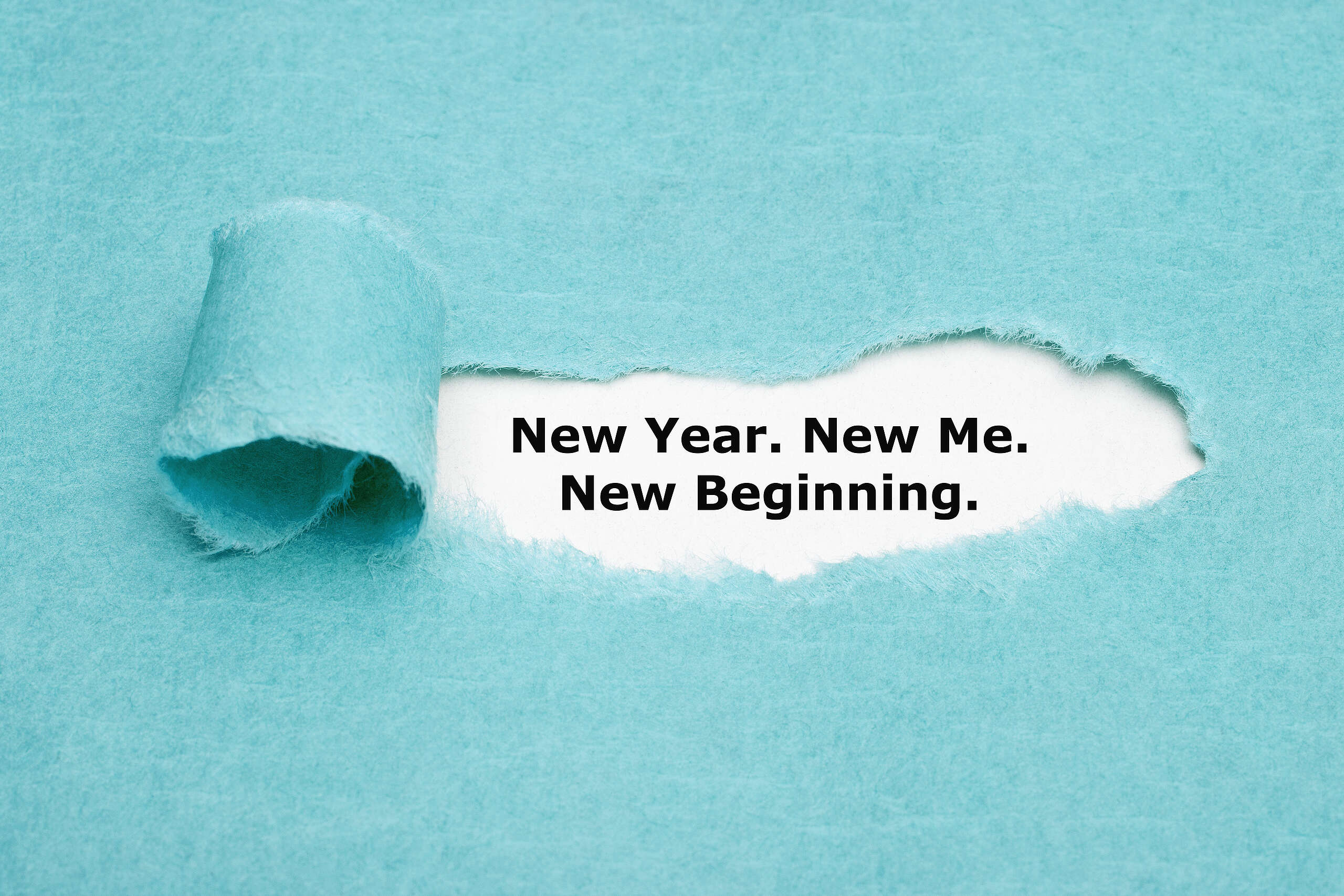 Blue paper peeling with the words underneath, "new year, new me"