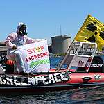 The Greenpeace Canada boat team supports the Ride for Renewables event during their inflatable boat training with a banner that reads “Stop Pickering” in front of the Pickering Nuclear Generating Station.