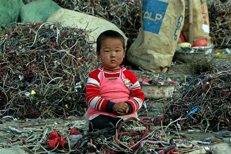 Chinese child surrounded by e-waste