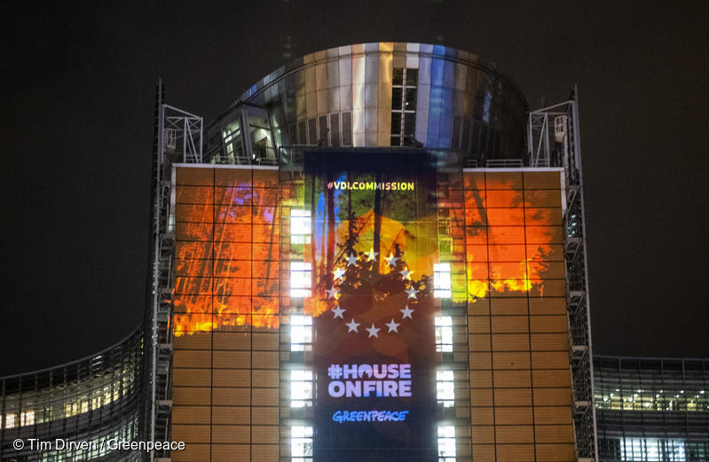 Projection of burning forests on the EU Commission. EU stars visible. #HouseOnFire / Greenpeace