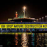 Greenpeace activists from several European countries at IJmuiden lock in the Netherlands are blocking a 225-meter-long soybean ship from Brazil. The mega-ship is part of a broken system that is linked to nature destruction. Every year, millions of tonnes of soy, palm oil or meat are shipped to and consumed in Europe: commodities from industries destroying nature across the world. Indigenous leaders Waduwabati Suyá and Alberto França Dias (Alberto Terena) from Brazil are joining the activity. The action is directed at EU ministers to support a strong new EU law that would put an end to European complicity in the destruction.