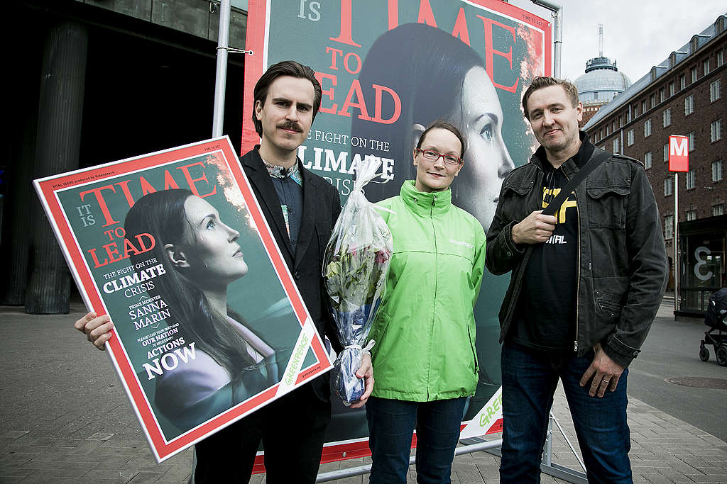 Matias Mäkynen (sdp) pitelee kädessään Greenpeacen imitaatiota Time-lehden Marin-kannesta. Mäkysen vieressä on Greenpeacen ilmasto- ja energia-asiantuntija Kaisa Kosonen sekä teoksen tehnyt kuvajournalisti Klaus Welp.