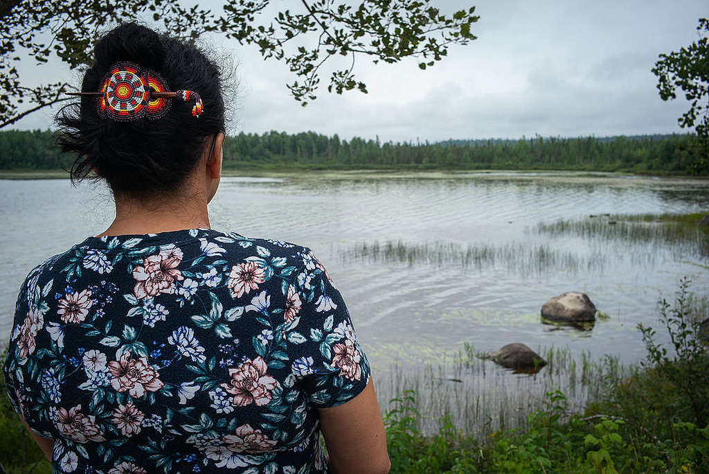 Alkuperäiskansan edustaja järven rannalla.
