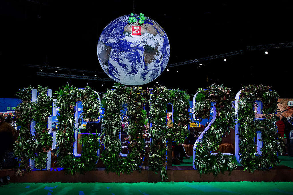 NOT FOR SALE” Banner against Iconic Giant Globe at COP26 In Glasgow. © Emily Macinnes / Greenpeace