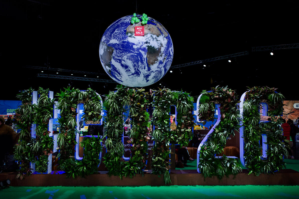 NOT FOR SALE” Banner against Iconic Giant Globe at COP26 In Glasgow. © Emily Macinnes / Greenpeace