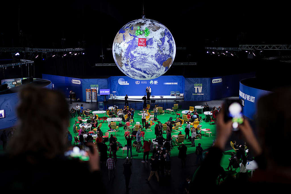 "Not For Sale" Banner on Iconic Giant Globe at COP26 in Glasgow. © Emily Macinnes / Greenpeace