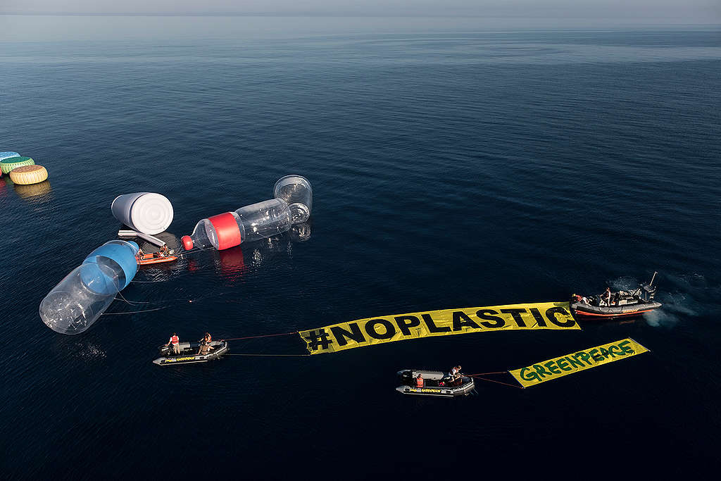 The Rainbow Warrior Invaded by Giant Plastic Packaging in the Med.