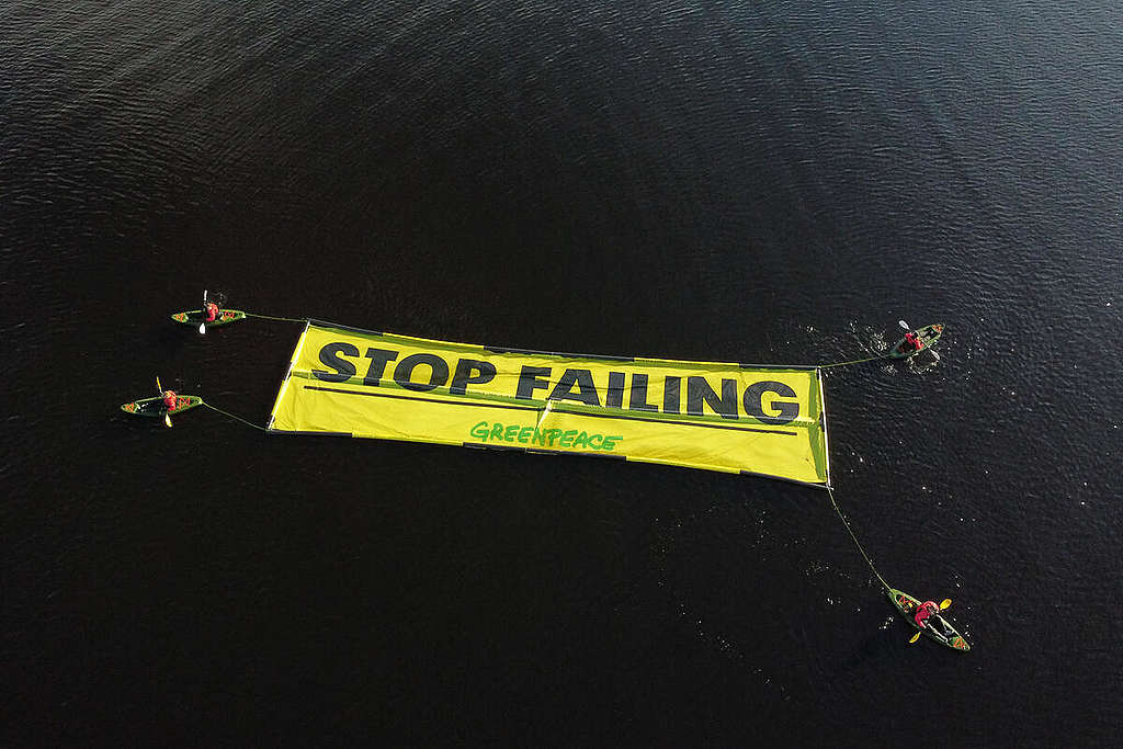 Kayakers with Floating Banner "Stop Failing" in Scotland. Kayakers with Floating Banner "Stop Failing" in Scotland.