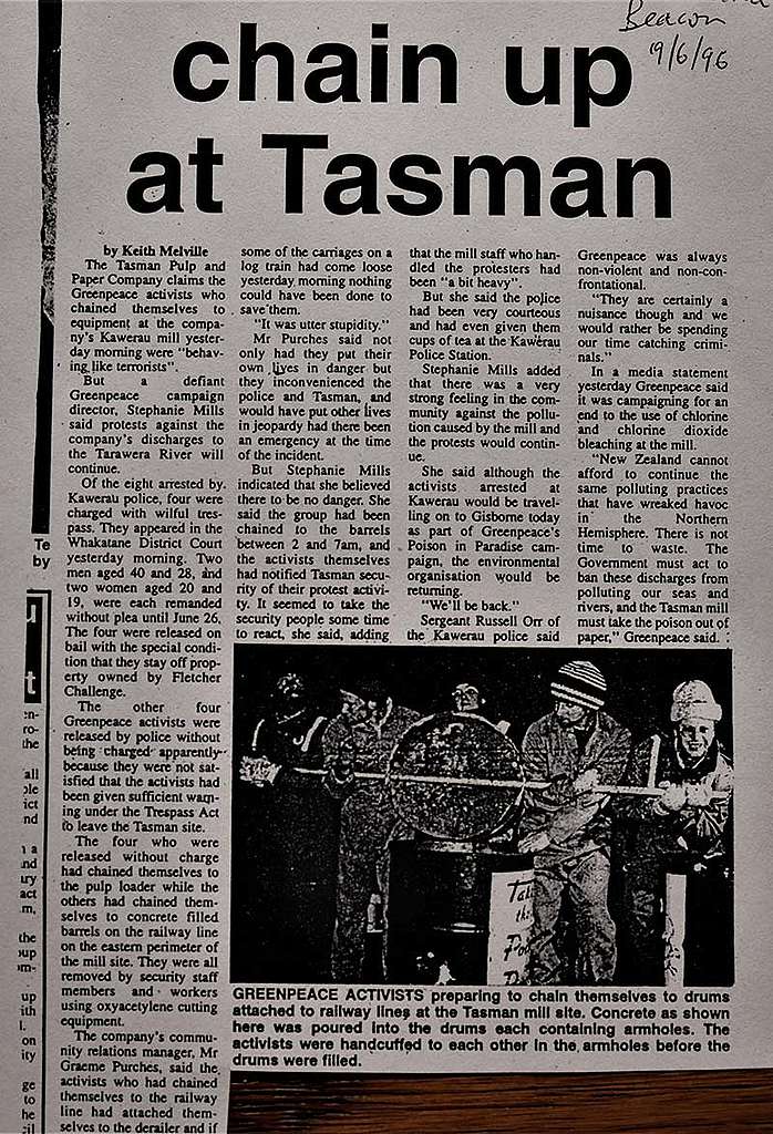 18 June 1996 Greenpeace activists chain themselves to concrete-filled barrels attached to railway tracks to stop a freight train of chlorine-bleached newsprint departing