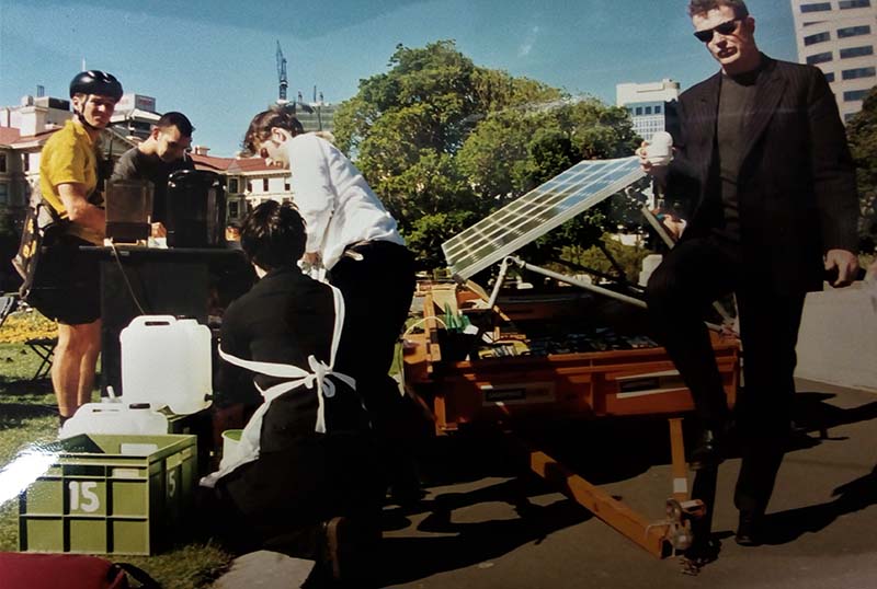 13 November 1997 Greenpeace Climate Campaigner Adam Laidlaw drinking a coffee from the Solar Café Greenpeace set up outside Parliament